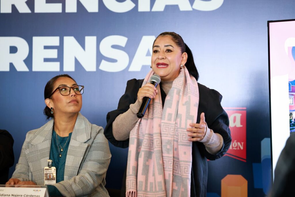 La secretaria de Turismo, Elizabeth Quintanar Gómez, habla con micrófono durante una conferencia de prensa para anunciar los detalles del Tianguis Nacional de Pueblos Mágicos.